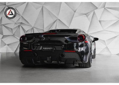 Luxury black Ferrari sports car in modern showroom. Designed for high performance, style, and speed. Perfect for car enthusiasts and collectors.