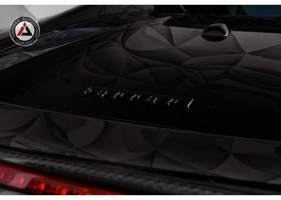 Sleek black sports car with Ferrari emblem, high-gloss finish, and aerodynamic design, showcasing luxury automobile craftsmanship and speed-focused styling for enthusiasts.