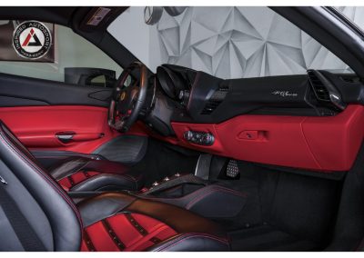 High-resolution shot of Ferrari interior featuring black and red leather seats, carbon fiber accents, and racing-inspired design elements for car enthusiasts.