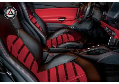 High-quality luxury car interior with red and black leather seats, racing-inspired design, and premium finishes from Inspired Autosport. Perfect for automotive enthusiasts and car modifications.