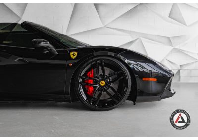 Luxury black Ferrari sports car with red brake calipers, sleek aerodynamic design, and iconic Ferrari emblem, perfect for high-performance driving.