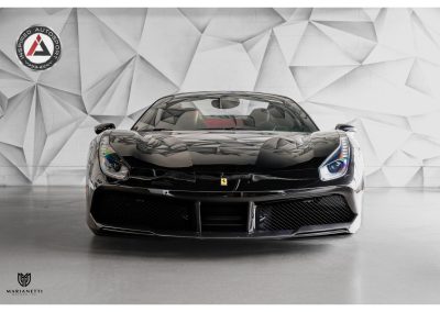 High-performance Ferrari sports car displayed at Inspired Autosport, showcasing luxury and speed with sleek black exterior and aerodynamic design.